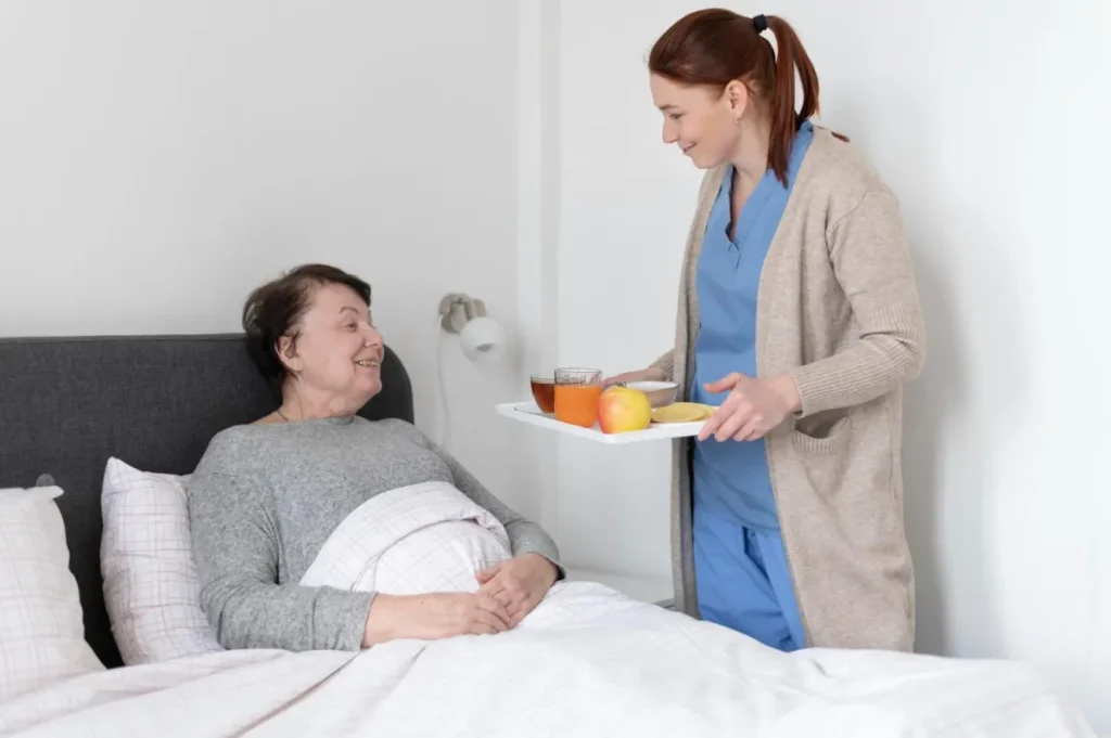 Nurse taking care of elderly woman in bed